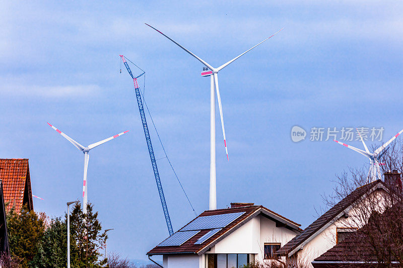 Building and assembling a construction wind turbine by crane near residential district. construction work at the windfarm in Wörrstadt, Germany. Energy saving concept from wind turbine construction